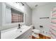 Bright bathroom featuring a white vanity, large mirror, and shower with striped curtain at 2205 Castle Royale Dr, Lawrenceville, GA 30043