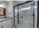 Updated bathroom featuring a glass-enclosed shower with white subway tile and granite countertop at 2205 Castle Royale Dr, Lawrenceville, GA 30043