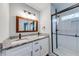 Modern bathroom with double vanity, granite countertop, and tiled shower with glass door at 2205 Castle Royale Dr, Lawrenceville, GA 30043