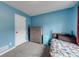 Bedroom with blue walls, carpet floors, and closet at 2205 Castle Royale Dr, Lawrenceville, GA 30043