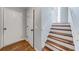 Hallway features wood stairs and a combination of carpet and hardwood floors leading to upper rooms at 2205 Castle Royale Dr, Lawrenceville, GA 30043