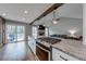 Well-equipped kitchen with a large island cooktop, sleek countertops, and an adjacent living area at 2205 Castle Royale Dr, Lawrenceville, GA 30043