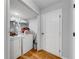 Functional laundry room with a washer, dryer, and storage shelves, providing convenience at 2205 Castle Royale Dr, Lawrenceville, GA 30043