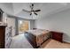 Spacious main bedroom features a ceiling fan, large window, and ample space for dressers at 2205 Castle Royale Dr, Lawrenceville, GA 30043