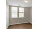 Simple bedroom with wood flooring, neutral walls, and two windows at 1177 Arlington Ave, Atlanta, GA 30310