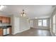 Combined kitchen and dining area with wood flooring and a chandelier at 1177 Arlington Ave, Atlanta, GA 30310