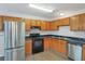 Kitchen boasts stainless steel appliances and wood cabinets at 1177 Arlington Ave, Atlanta, GA 30310