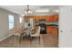 Modern kitchen with wooden cabinets, stainless steel appliances, and a dining area at 1177 Arlington Ave, Atlanta, GA 30310