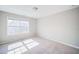 Spacious bedroom with carpet flooring and a large window at 1216 Foxcroft Ln, Cumming, GA 30041