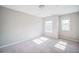 Well-lit bedroom with carpet flooring and two windows at 1216 Foxcroft Ln, Cumming, GA 30041