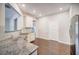 Modern kitchen with white cabinets, granite countertops, and stainless steel appliances at 1216 Foxcroft Ln, Cumming, GA 30041