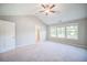 Main bedroom with vaulted ceiling, carpeting and access to bathroom at 1216 Foxcroft Ln, Cumming, GA 30041