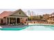 Community pool with clubhouse and lounge chairs at 1216 Foxcroft Ln, Cumming, GA 30041