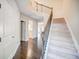 Elegant staircase with dark wood railing and flooring at 1216 Foxcroft Ln, Cumming, GA 30041