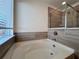 Bathroom featuring a garden tub and walk-in shower at 1814 Emory Ln # 92, Conyers, GA 30013