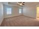 Large bedroom with two windows, carpet, and access to bathroom at 1814 Emory Ln # 92, Conyers, GA 30013