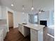 Modern kitchen with white cabinets, quartz countertops, and island at 1814 Emory Ln # 92, Conyers, GA 30013