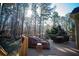 Deck with wooded backdrop, seating area, and sun umbrella at 37 Waterstone Se Dr, Cartersville, GA 30121