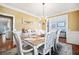 Formal dining room with chandelier and view into kitchen at 37 Waterstone Se Dr, Cartersville, GA 30121