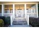 Inviting front porch with white columns and stone steps at 37 Waterstone Se Dr, Cartersville, GA 30121