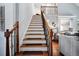 Impressive staircase with wooden railings and brown carpet runners at 37 Waterstone Se Dr, Cartersville, GA 30121