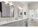 Modern bathroom with double vanity, marble flooring, and a view of the bedroom at 396 Pratt Se Dr # 1932, Atlanta, GA 30315