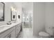 Bright bathroom featuring double vanity, modern fixtures, and an open doorway to the bedroom with a glass shower stall at 396 Pratt Se Dr # 1932, Atlanta, GA 30315