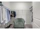 Organized walk-in closet with ample shelving, hanging space, chair, and carpeted floor at 396 Pratt Se Dr # 1932, Atlanta, GA 30315