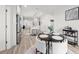 Bright dining area featuring modern lighting, open to kitchen, with seating for four and a stylish bar cart at 396 Pratt Se Dr # 1932, Atlanta, GA 30315