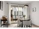 Bright dining area featuring modern lighting, with a round table, seating for four, and access to the balcony at 396 Pratt Se Dr # 1932, Atlanta, GA 30315