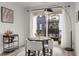 Bright dining area with a round table, seating for four, a bar cart and access to the outdoor balcony at 396 Pratt Se Dr # 1932, Atlanta, GA 30315