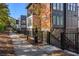 Townhome complex featuring brick base, a sidewalk lined with fallen leaves and stair access at 396 Pratt Se Dr # 1932, Atlanta, GA 30315