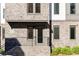 Front entrance of a brick townhome featuring modern design and well-kept landscaping at 396 Pratt Se Dr # 1932, Atlanta, GA 30315
