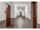 Well-lit hallway featuring doors for storage units and rooms with hardwood floors and painted walls at 396 Pratt Se Dr # 1932, Atlanta, GA 30315