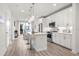 Modern kitchen features white cabinets, quartz countertops, stainless steel appliances, and a center island with bar seating at 396 Pratt Se Dr # 1932, Atlanta, GA 30315