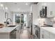 Modern kitchen showcases stainless steel appliances, white cabinetry, and an island with seating overlooking the dining area at 396 Pratt Se Dr # 1932, Atlanta, GA 30315