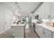 Bright kitchen featuring quartz countertops, stainless steel appliances, modern lighting, and a central island at 396 Pratt Se Dr # 1932, Atlanta, GA 30315