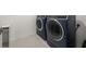 The laundry room has a modern navy washer and dryer set with a shelf, creating a functional and stylish space at 396 Pratt Se Dr # 1932, Atlanta, GA 30315