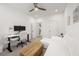 Bright living room boasts a white sofa, modern desk, and ceiling fan creating a comfortable and functional space at 396 Pratt Se Dr # 1932, Atlanta, GA 30315