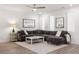 Bright living room featuring a gray sectional sofa, white rug, and neutral decor with ample natural light at 396 Pratt Se Dr # 1932, Atlanta, GA 30315