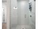 Modern shower with a glass door, white tiled walls, and a chrome shower head at 396 Pratt Se Dr # 1932, Atlanta, GA 30315