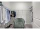 Organized walk-in closet with wire shelving, hanging clothes, and a comfortable armchair, offering ample storage space at 396 Pratt Se Dr # 1932, Atlanta, GA 30315