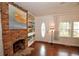 Cozy living room featuring a brick fireplace and built-in shelving at 4038 Wesley Chapel Rd, Marietta, GA 30062