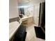 Bathroom with a large soaking tub, modern vanity, and bright natural light at 232 Spalding Drive Dr, Atlanta, GA 30328