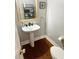 Pedestal sink and toilet with wood flooring at 232 Spalding Drive Dr, Atlanta, GA 30328