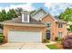 Brick house with a two-car garage and landscaped lawn at 232 Spalding Drive Dr, Atlanta, GA 30328