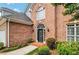 Brick front entry with a black door and arched window at 232 Spalding Drive Dr, Atlanta, GA 30328