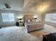 Spacious main bedroom featuring plush carpet, a ceiling fan, and plenty of natural light at 232 Spalding Drive Dr, Atlanta, GA 30328