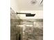 Modern shower with a rain shower head and gray marbled tile at 232 Spalding Drive Dr, Atlanta, GA 30328