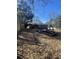 Large backyard with mature trees and a partially visible fence at 1214 Lloyd Dr, Forest Park, GA 30297